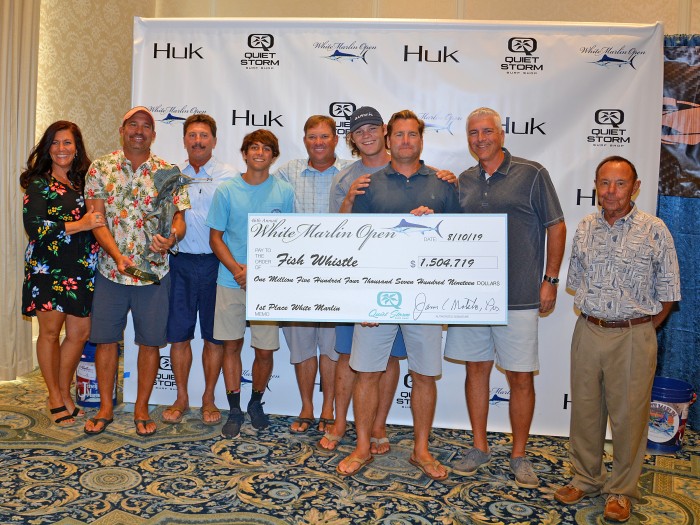 Fish Whistle team with winning check for 1.3 million