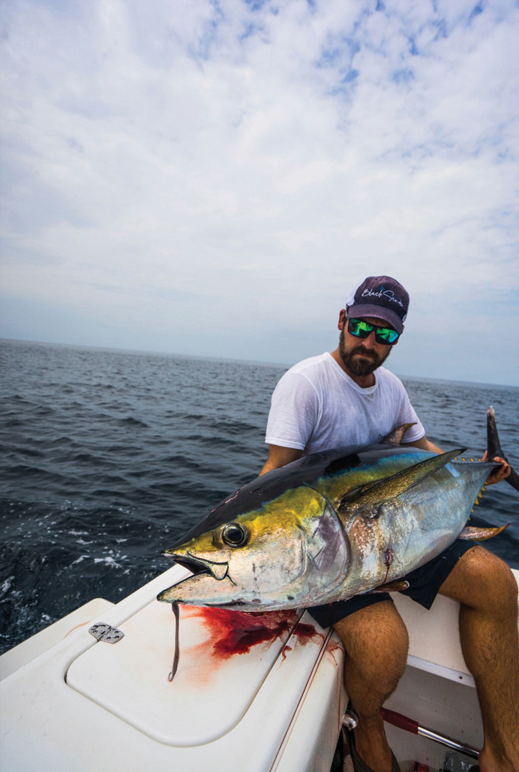  a fisherman holding a nice yellowfin tuna