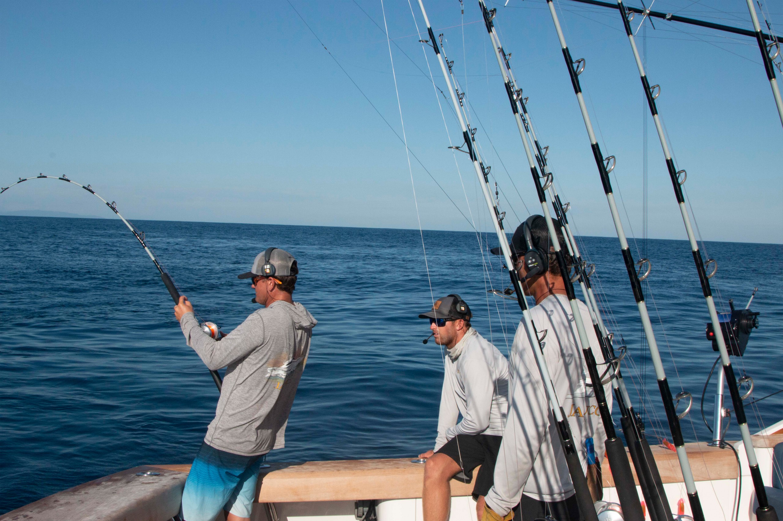 angler hooked up to a fish with the rod bent