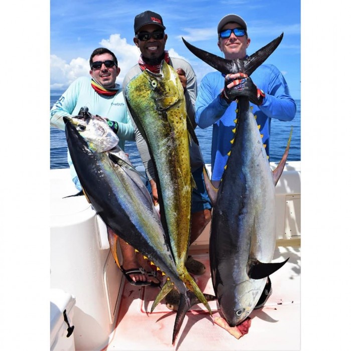 guys holding a two tuna and a mahi