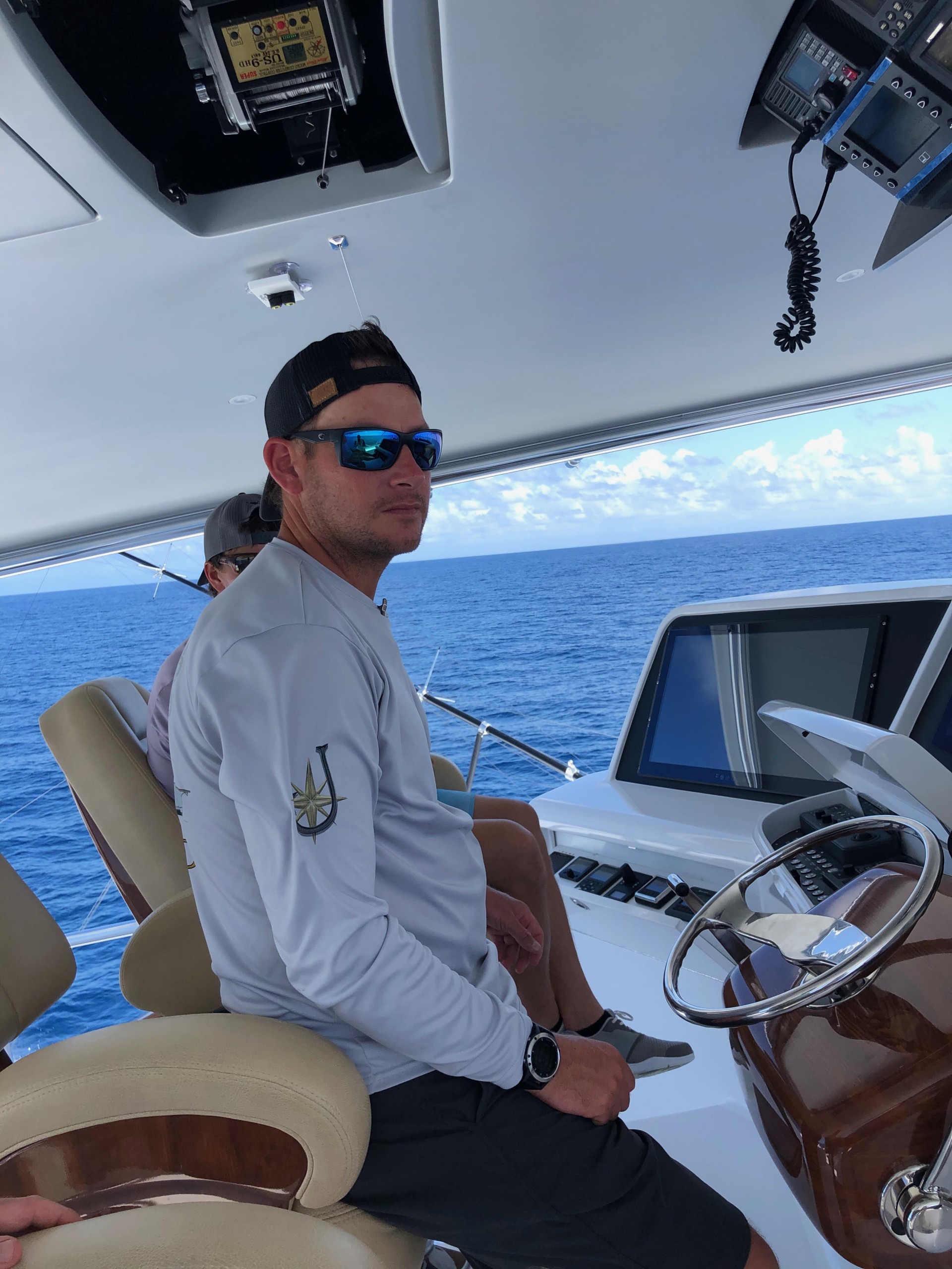 Jaruco Captain Jimmy Brown looking out on ocean from the bridge helm