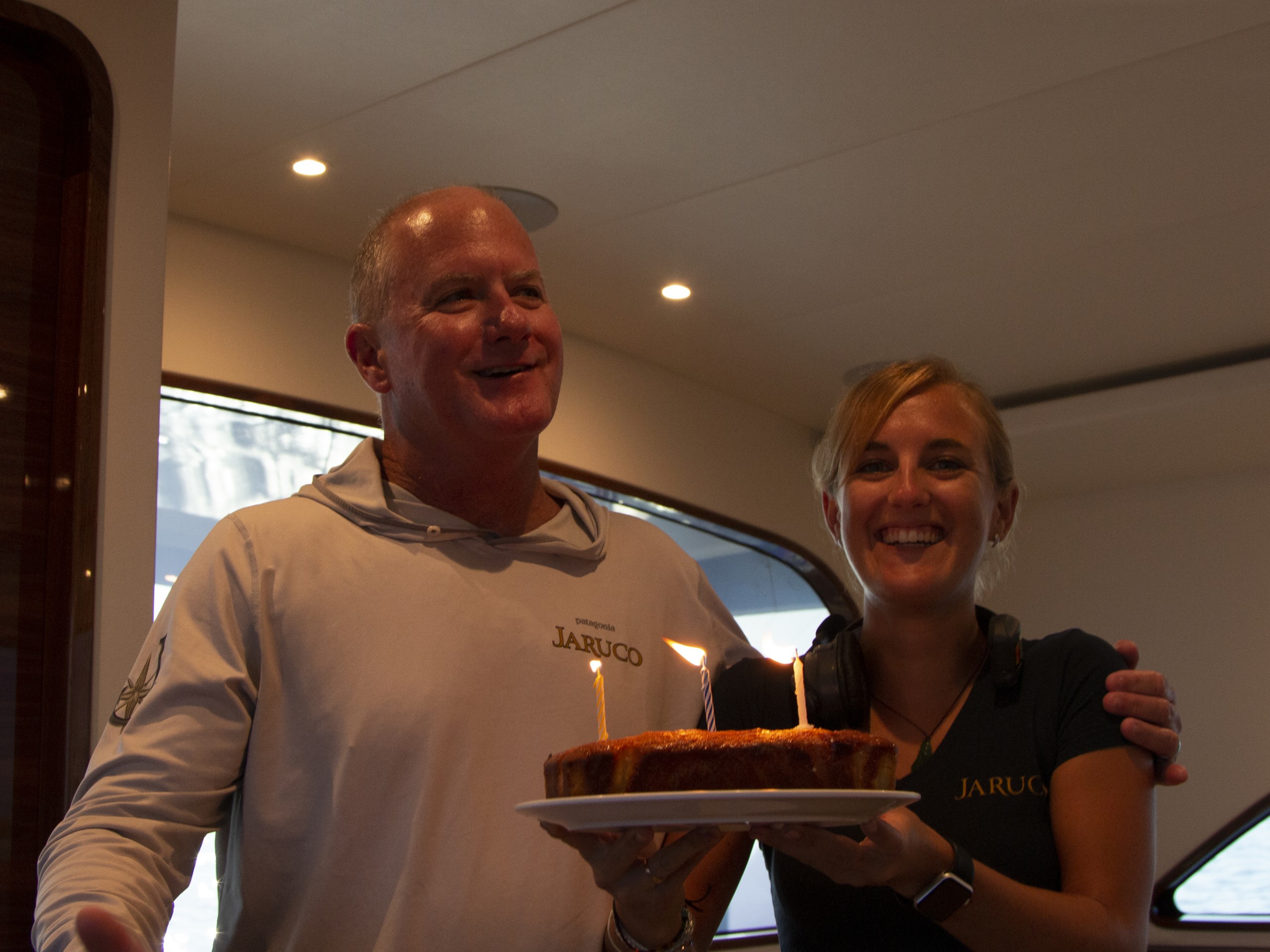 a guy and girl with a birthday cake