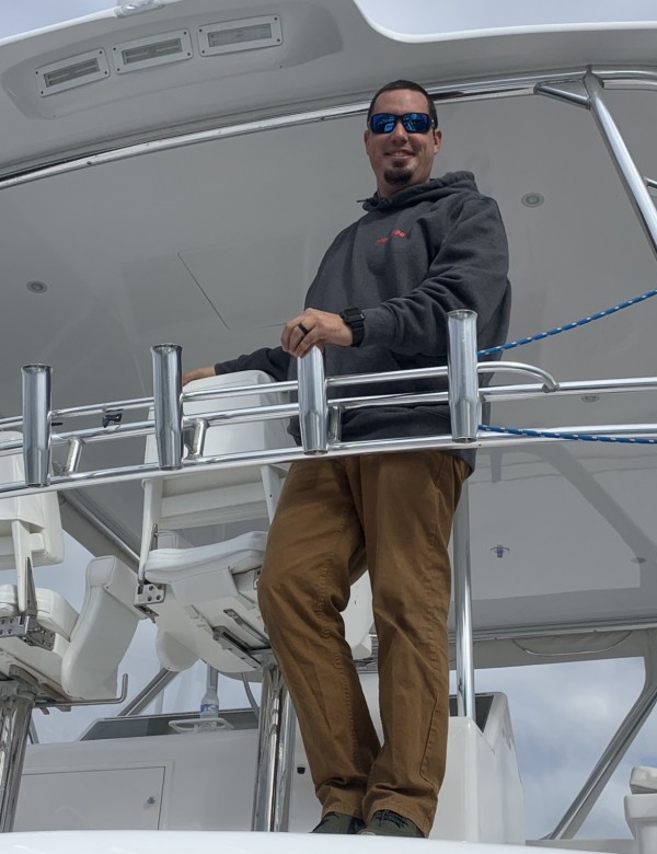 captain ryan knapp standing on his boat