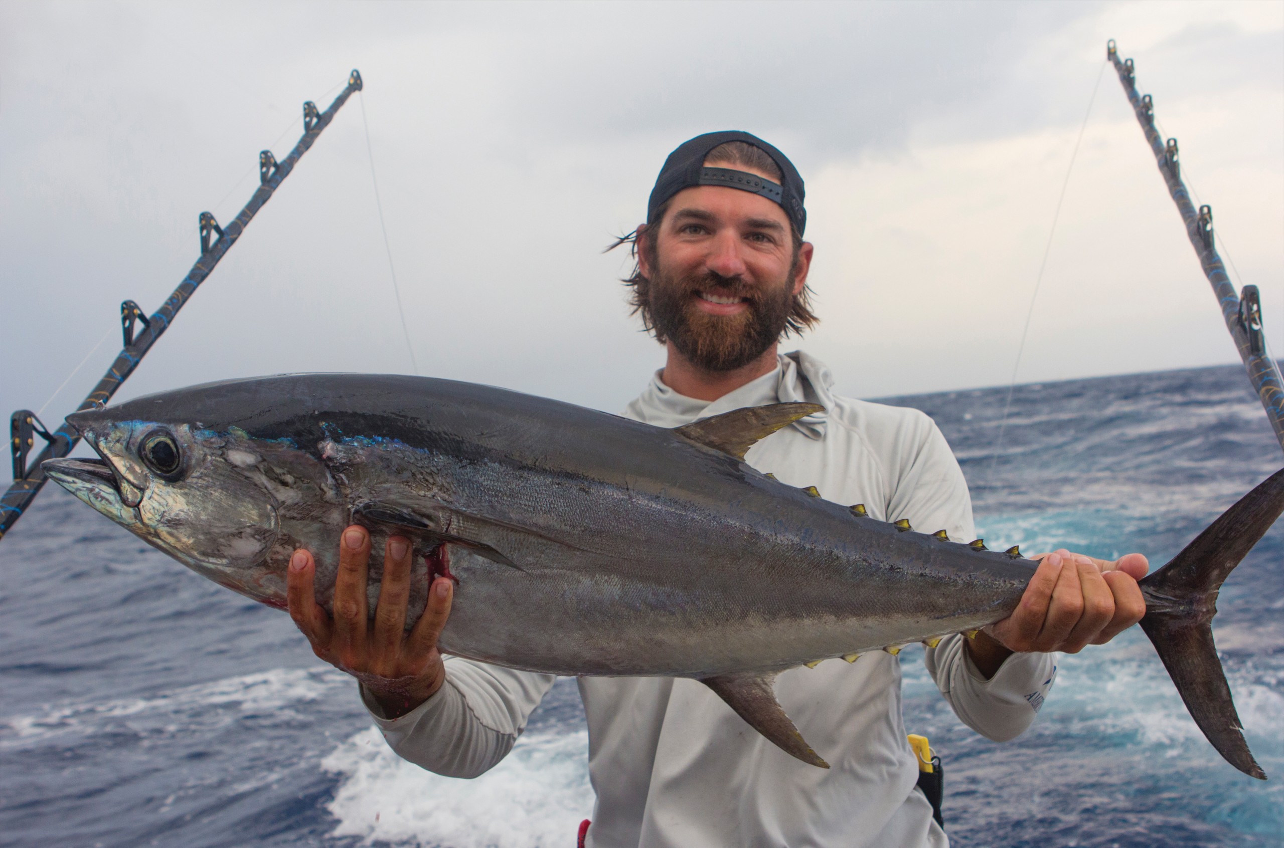holding up a dead yellowfin tuna