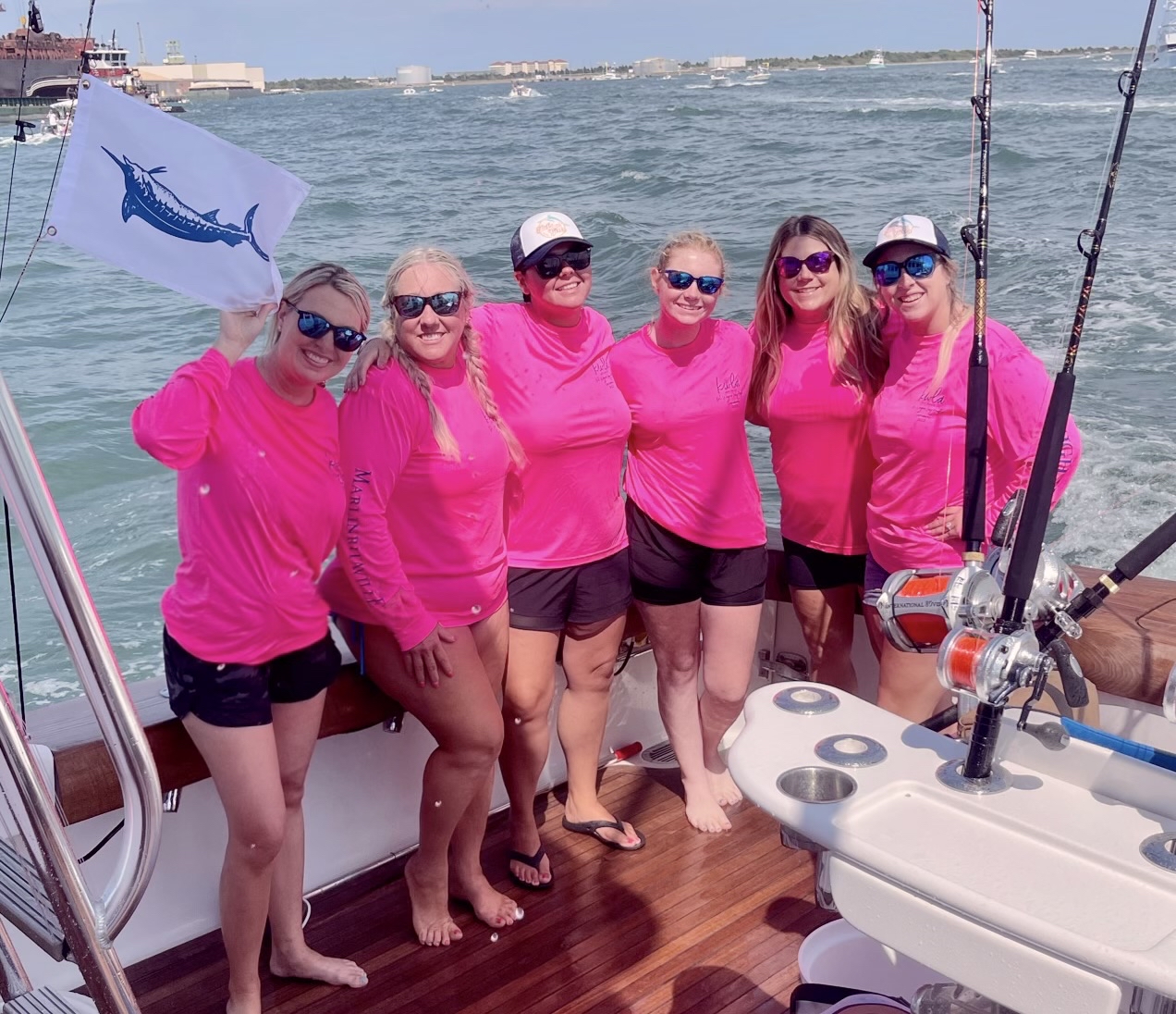 Diana posing with other women on boat at KWLA tournament