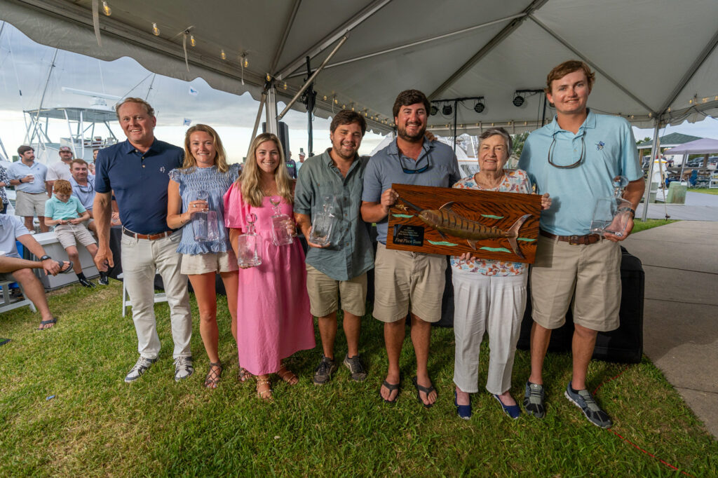 The crew of the Blue Bill posing with their first-place plaque.